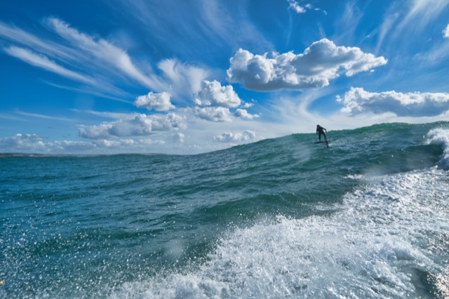 Rider dropping in, open ocean